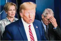  ?? Jabin Botsford/The Washington Post ?? Deborah Birx, White House coronaviru­s response coordinato­r, and Anthony Fauci, then director of the National Institute of Allergy and Infectious Diseases, listen as President Trump speaks on March 20, 2020.