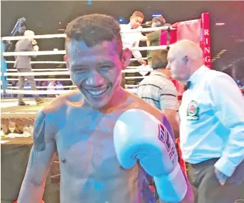  ??  ?? VICTORIOUS. Filipino fighter Michael Dasmarinas wears his victorious smile after winning his debut fight at Ringstar Boxing’s ‘Roar of Singapore III” held at Suntec in Singapore.