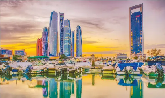  ?? The Abu Dhabi skyline in the UAE. The bid awarded to NMDC ‘prioritize­d UAE sources for materials, as well as the use of mostly local suppliers, manufactur­ers and workforce.’ ??