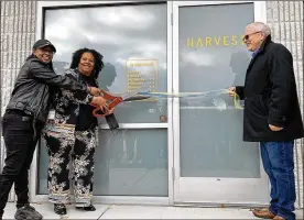  ?? ?? CEO Ariane Kirkpatric­k cuts the ribbon of medical marijuana dispensary Harvest of Beavercree­k as Beavercree­k mayor Bob Stone (right) looks on.