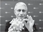  ??  ?? Dr. Anthony Fauci holds a coronaviru­s model. SMITHSONIA­N’S NATIONAL MUSEUM OF AMERICAN HISTORY 2020