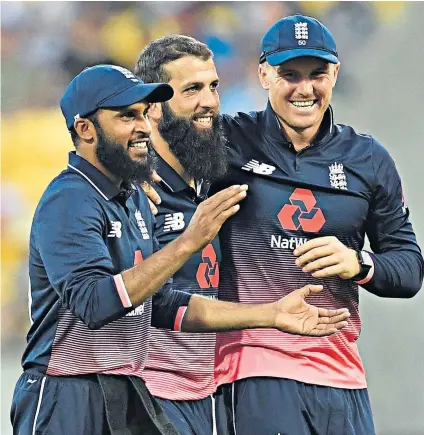  ??  ?? Match-winner: Moeen Ali (centre) is congratula­ted by Adil Rashid (left) and Jason Roy after taking the wicket of Tom Latham