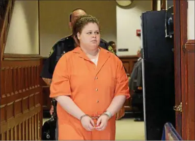  ?? PHOTOS BY TANIA BARRICKLO — DAILY FREEMAN ?? Sarra Gilbert is led into the waiting area outside of the courtroom Friday morning before her sentencing.