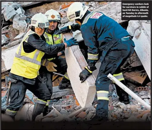 ??  ?? Emergency workers look for survivors in rubble of hard-hit Durres, Albania, on Tuesday in aftermath of magnitude 6.4 quake.