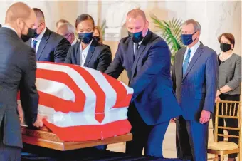  ?? ANDREW HARNIK/ASSOCIATED PRESS ?? Chief Justice of the United States John Roberts, second from right, and Justice Elena Kagan, right, watch as the casket of Justice Ruth Bader Ginsburg arrives at the Supreme Court in Washington Wednesday.