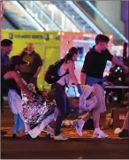  ??  ?? Carrying victims to safety after the Las Vegas massacre.