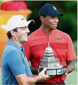  ?? — AFP ?? Sharing the joy: Francesco Molinari (left) celebratin­g his victory in the Quicken Loans National with Tiger Woods at the TPC Potomac in Maryland on Sunday.