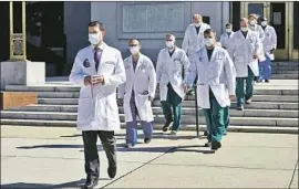  ?? Susan Walsh Associated Press ?? DR. SEAN CONLEY, physician to President Trump, leads a medical team for a news briefing Saturday at Walter Reed National Military Medical Center.