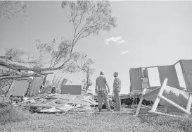  ?? Mark Mulligan / Houston Chronicle file ?? Volunteers survey the damage at a home destroyed by Hurricane Harvey in Bayside in September. Texas lawmakers signed a letter pleading for the Senate to pass a U.S. House bill providing disaster relief funds.