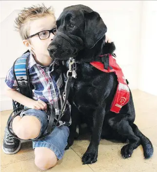  ?? FACEBOOK ?? Ontario’s human rights tribunal says nine-year-old Kenner Fee’s family failed to prove that bringing his service dog, a black Lab named Ivy, with him into the classroom would help with his education.