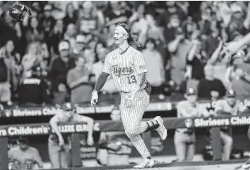  ?? Elizabeth Conley / Staff photograph­er ?? LSU infielder Jordan Thompson tosses his helmet as he makes his way home after hitting a walkoff home run in the bottom of the 11th inning against Oklahoma Friday night at Minute Maid Park.