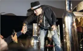  ??  ?? Actor Johnny Depp greets fans at the Glastonbur­y music festival at Worthy Farm, in Somerset, England, Thursday.