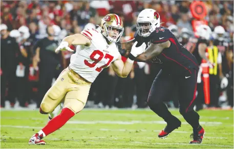  ?? RaLPH FRESO/GETTY IMAGES ?? Defensive lineman Nick Bosa, left, looks like a rookie of the year candidate at the halfway point of the NFL season, doing his part on a San Francisco 49ers defence that led the league in total defence before their victory over the Arizona Cardinals Thursday night.