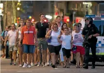  ?? PHOTO: REUTERS ?? Police evacuate people from the Las Ramblas area after the attack, the deadliest terror incident in Spain since March 2004.