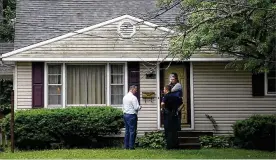  ?? TY GREENLEES / STAFF ?? Dunkin (left) and Olson wait at a residence with Dayton’s Deputy City manager Joe Parlette as they try to connect with opioid addicts. “When we are speaking to them, let them know that I understand ... let them know that they’re not alone.”