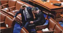  ?? J. SCOTT APPLEWHITE/ASSOCIATED PRESS ?? Lawmakers evacuate the floor as a mob tries to break into the House Chamber.