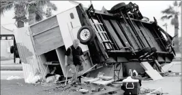  ?? ASSOCIATED PRESS ?? TODD WITHERINGT­ON SEARCHES HIS TRAILER THAT WAS OVERTURNED by Hurricane Harvey on Monday in Aransas Pass, Texas.