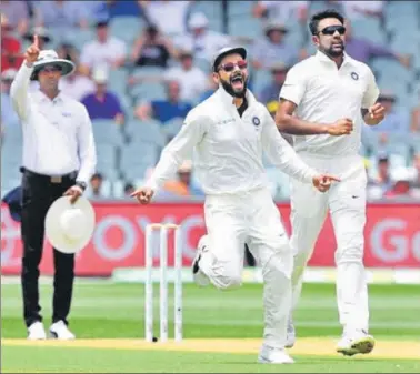  ?? REUTERS ?? ■ Virat Kohli and Ravichandr­an Ashwin celebrate the dismissal of Marcus Harris (not in the picture) during the second day of the first Test between Australia and India at the Adelaide Oval on Friday. India are still 59 runs ahead.