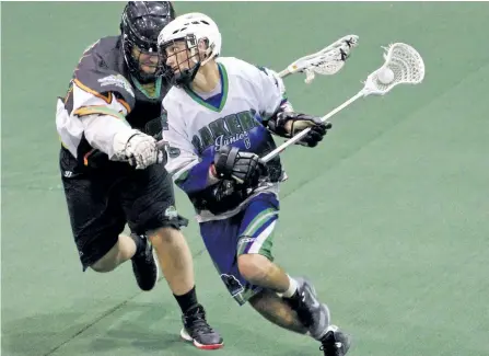  ?? JESSICA NYZNIK/EXAMINER ?? Peterborou­gh MinCom Kawartha Lakes Realty Jr. C Lakers Adam Churchill looks for a line to the net while Clarington Shamrox Steve Jones defends during OJCLL East Division Final Game 4 at the Memorial Centre Monday night. The Shamrox beat the Lakers 8-4....