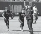  ?? BRYAN TERRY/THE OKLAHOMAN ?? Tuttle’s Cami Cobb, right, celebrates after winning the Class 4A state softball championsh­ip last October.