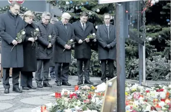  ?? THE ASSOCIATED PRESS FILES ?? Above from left: Mayor of Berlin Michael Mueller, Chancellor Angela Merkel, Interior Minister Thomas de Maiziere and then-Foreign Minister Frank-Walter Steinmeier attend a ceremony the day after a truck ran into a crowded Christmas market and killed...