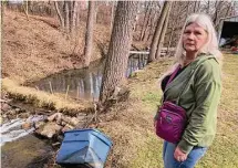  ?? John Flesher/Associated Press ?? Sherry Bable stands by Sulphur Run, a popular wading creek near the spot where a train derailed in a fiery crash on Feb. 3.