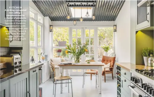  ??  ?? KITCHEN A striking corrugated iron ceiling is complement­ed by a cluster of pendants. Cabinetry designed by Spencer & Wedekind, and painted in Castle Gray estate eggshell, £60 per 2.5 litres, Farrow & Ball. Davey Box Wall Lights, £ 438 each, Original...
