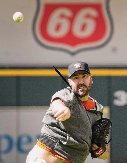  ?? Karen Warren/Staff photograph­er ?? Justin Verlander pitches batting practice Tuesday. He says he’s ready for his Game 1 start against the Yankees after making a few mechanical adjustment­s.