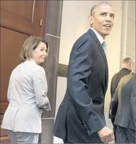  ?? Michael Reynolds European Pressphoto Agency ?? PRESIDENT OBAMA and House Minority Leader Nancy Pelosi caucus before Friday’s vote on trade legislatio­n. The trade fight was an epic intraparty­mudfest.