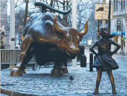  ?? (Brendan McDermid/Reuters) ?? A STATUE of a girl faces the Wall Street bull in New York’s financial district on Tuesday.