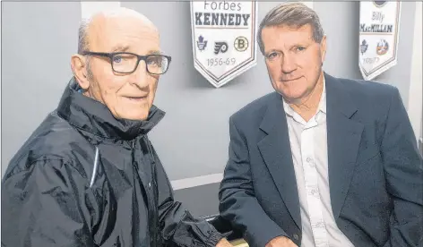  ?? MITCH MACDONALD/THE GUARDIAN ?? Forbes Kennedy, left, and Gary MacDougall meet up at Eastlink Centre prior to the launch of MacDougall’s book on the former NHLer, which will be titled “Forbie.” Behind the two is a banner that hangs in the centre’s lobby that recognizes Kennedy and his impact on the hockey world.