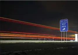  ?? BRETT CARLSEN — THE NEW YORK TIMES ?? In this multiple-exposure image, a highway sign near Nichols, N.Y., encourages drivers to stop at a rest area for safe texting in April 2016. More than a decade after federal and state government­s seized on the dangers that cellphone use while driving posed and began enacting laws to stop it, there remains no definitive database of the number of crashes or fatalities caused by cellphone distractio­n.