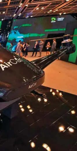  ??  ?? Top: Visitors stand next to a concept flying car at the Gitex 2020 summit on December 8, 2020