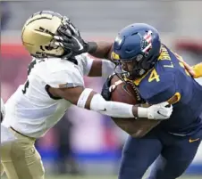  ??  ?? Mountainee­rs running back Leddie Brown stiff-arms Army defensive back Jabari Moore.