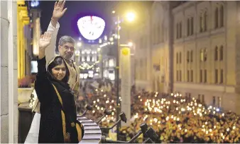  ?? FREDRIK VARFJELL/GETTY IMAGES ?? Nobel Peace Prize laureates Malala Yousafzai, left, and India’s Kailash Satyarthi wave from the balcony of the Grand Hotel ahead of the Nobel banquet in Oslo in December of 2014.