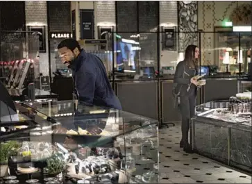  ?? Susan Allnutt Warner Bros. ?? TIRED of being “Locked Down,” Chiwetel Ejiofor and Anne Hathaway attempt to rob London’s Harrods.