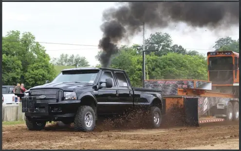  ??  ?? After trekking 650 miles down from southern Wisconsin, Dan Gilbertson put this impeccably clean Super Duty to work against the sled. The ’02 F-350 conceals a built engine with massive 500/400 Full Force Diesel injectors, a Gen3 over an Adrenaline, an S482 by way of an Irate Diesel T4 mount, and a BTS 4R100.