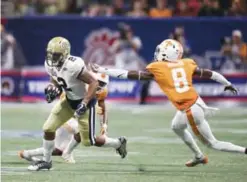  ??  ?? ATLANTA: Georgia Tech wide receiver Ricky Jeune (2) escapes from Tennessee defensive back Justin Martin (8) after catching a pass in the first half of an NCAA college football game, Monday, in Atlanta. — AP