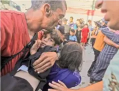  ?? YOUSEF MASOUD/THE NEW YORK TIMES ?? Injured civilians are rescued from the rubble of a destroyed house Saturday following Israeli air strikes near a UNRWA school currently housing displaced people in Khan Younis, southern Gaza.