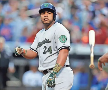  ?? ADAM HUNGER / USA TODAY SPORTS ?? Brewers first baseman Jesus Aguilar tosses his bat after striking out looking against the Mets on Monday.