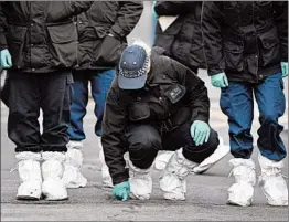  ?? ALBERTO PEZZALI/AP ?? Police officers work at the scene of Sunday’s terror attack Monday in the Streatham area of south London.