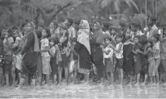  ?? AP ?? Rohingya Muslims stand in line for food near Balukhali refugee camp in Cox’s Bazar, Bangladesh.