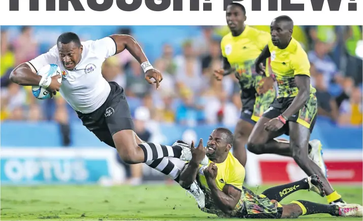  ?? Photo: Zimbio ?? Team Fiji men’s rugby 7s prop Paula Dranisinuk­ula cops a tackle against Uganda during their pool clash at the Commonweal­th Games in Robina Stadium in Gold Coast, Australia on April 14, 2018. Fiji won 54-0. Earlier in the day they thrashed Sri Lanka 53-5.