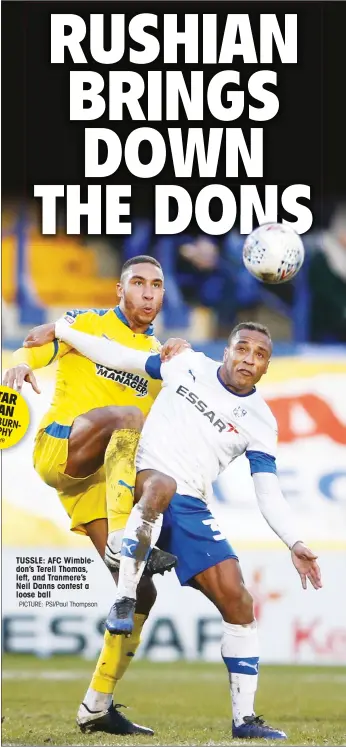  ?? PICTURE: PSI/Paul Thompson ?? TUSSLE: AFC Wimbledon’s Terell Thomas, left, and Tranmere’s Neil Danns contest a loose ball