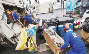  ??  ?? TRASLACION TRASH – Litter thrown by devotees of the Black Nazarene during Tuesday’s Traslacion around Quiapo Church in Manila is hauled off Wednesday. (Czar Dancel)