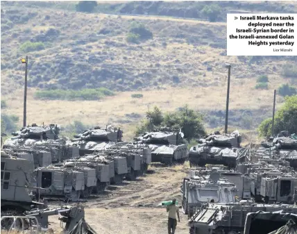  ?? Lior Mizrahi ?? > Israeli Merkava tanks deployed near the Israeli-Syrian border in the Israeli-annexed Golan Heights yesterday