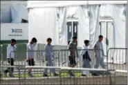  ?? WILFREDO LEE, FILE - THE ASSOCIATED PRESS ?? In this Feb.19 file photo, children line up to enter a tent at the Homestead Temporary Shelter for Unaccompan­ied Children in Homestead, Fla. A government spokesman says President Donald Trump’s administra­tion is evaluating vacant properties near five U.S. cities as potential permanent sites to hold unaccompan­ied migrant children. Department of Health and Human Services spokesman Mark Weber said Wednesday that property is being assessed in and around Atlanta; Phoenix; Dallas; Houston; and San Antonio, Texas.