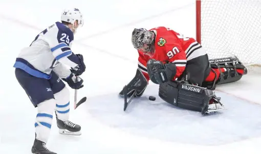  ?? AP ?? Emergency goalie Scott Foster makes a save on a point- blank shot by the Jets’ Paul Stastny in the third period Thursday.