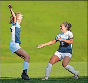  ?? SEAN D. ELLIOT/THE DAY ?? Conn College’s Kat Norton, left, races to celebrate her second goal against Trinity with teammate Zoe Stublarec in NESCAC women’s soccer action Tuesday.