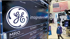  ?? AP file photo ?? The General Electric logo appears on a screen above a trading post on the floor of the New York Stock Exchange in mid-June. The company on Friday reported revenue of $29.56 billion in its quarterly report.